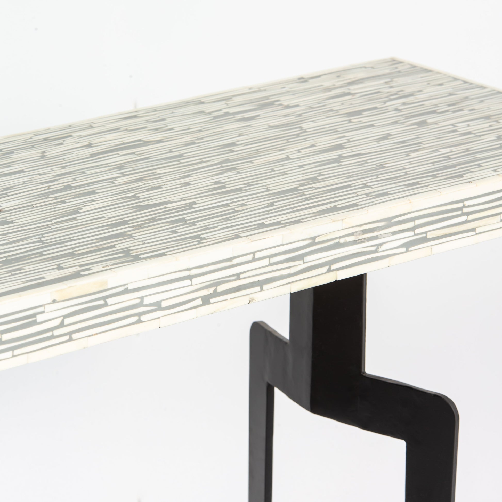 Table with a mosaic pattern on the surface and black legs